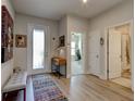 Bright and airy entryway with wood flooring and a bench at 1002 Chelan Falls Dr, Deland, FL 32724