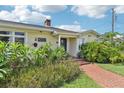 House exterior featuring a charming front porch and lush landscaping at 12 Foster Dr, Daytona Beach, FL 32118