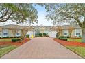 Front view of two villas with paved driveway and landscaping at 121 Sedona Cir, Daytona Beach, FL 32124