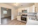 Updated kitchen featuring white cabinets and stainless steel appliances at 1210 Washington St, New Smyrna Beach, FL 32168