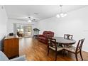 Bright dining room with hardwood floors and access to a patio at 122 Turnbull Villas Cir, New Smyrna Beach, FL 32168