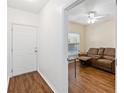 View of entryway with white door, leading to living room with brown recliner at 122 Turnbull Villas Cir, New Smyrna Beach, FL 32168