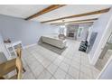 Spacious living room with exposed wooden beams, fireplace, and tile floors at 1253 Harbour Point Dr, Port Orange, FL 32127