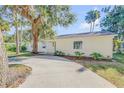 House exterior showcasing a light yellow facade, landscaping, and driveway at 142 Jean Francis Ln, Port Orange, FL 32127