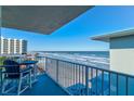 Balcony view of the ocean, beach, and other buildings at 1571 S Atlantic Ave # 4110, New Smyrna Beach, FL 32169