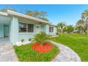 Landscaped front yard with a paved walkway leading to the entrance at 211 Maurice Ave, New Smyrna Beach, FL 32168