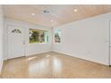 Bright living room with wood ceiling, new flooring, and lots of natural light at 211 Maurice Ave, New Smyrna Beach, FL 32168