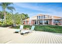 Relaxing dock area with lounge chairs and beautiful water views at 236 Quay Assisi, New Smyrna Beach, FL 32169