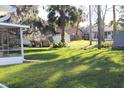 Large backyard with a shed and lush green grass at 2408 Victory Palm Dr, Edgewater, FL 32141