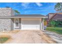 White garage door and stone exterior wall at 2507 Milton Ave, New Smyrna Beach, FL 32168