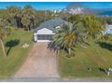 House with paver driveway, screened garage, and waterfront views at 258 Navajo Dr, Oak Hill, FL 32759