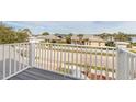 Deck balcony overlooking a tree-lined street and neighborhood homes at 2817 Bay Side Dr, New Smyrna Beach, FL 32168