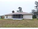 House exterior showcasing a screened porch and backyard at 3020 Kumquat Dr, Edgewater, FL 32141