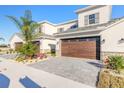 Two-story house with a brown garage door and paved driveway at 3055 Isles Way, New Smyrna Beach, FL 32168