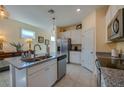 Kitchen island with granite countertop and stainless steel appliances at 3191 Crab Trap Dr, New Smyrna Beach, FL 32168