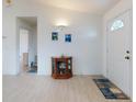 Bright entryway with wood-look floors and a display cabinet at 3220 Tamarind Dr, Edgewater, FL 32141