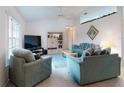 Living room with light teal sofas and a large TV at 3220 Tamarind Dr, Edgewater, FL 32141