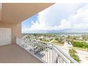 Balcony view with a white door and railing overlooking the city and waterways at 3851 S Atlantic Ave # 701, Daytona Beach Shores, FL 32118