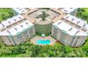 Aerial view of condo building with pool and surrounding landscape at 4 Oceans West Blvd # 502B, Daytona Beach, FL 32118