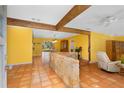 Bright living room with a stone accent wall and terracotta tile floors at 4045 Jason St, New Smyrna Beach, FL 32168