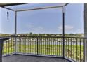 A screened balcony showing water views with boats and lush green vegetation at 432 Bouchelle Dr # 403, New Smyrna Beach, FL 32169