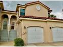 Front view of a two-story condo with a two-car garage at 439 Bouchelle Dr # 202, New Smyrna Beach, FL 32169