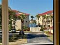 Partial water view from condo, showing other buildings and landscaping at 439 Bouchelle Dr # 202, New Smyrna Beach, FL 32169