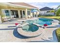 Relaxing freeform pool and spa with outdoor seating at 508 Campana St, New Smyrna Beach, FL 32168