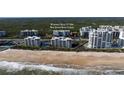 Aerial view of oceanfront community, showcasing beach and building at 5300 S Atlantic Ave # 17-206, New Smyrna Beach, FL 32169