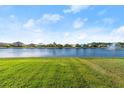 Picturesque backyard view overlooking a serene lake and lush green lawn at 5340 Bear Corn Run, Port Orange, FL 32128