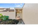 View of the front entryway showing a stone walkway leading to the glass-paneled front door at 632 Sausalito Blvd, Casselberry, FL 32707