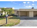 View of the front exterior, showing the address, covered parking, and manicured lawn at 632 Sausalito Blvd, Casselberry, FL 32707