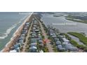 Aerial view showing home's location in beachfront community near waterway at 6911 Turtlemound Rd, New Smyrna Beach, FL 32169