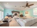 Spacious living room featuring a white sectional sofa and a unique fireplace at 708 Ocean Ave, New Smyrna Beach, FL 32169