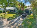 Aerial view of a ranch home with a driveway and a neatly kept yard at 729 N Flamingo Dr, Daytona Beach, FL 32117