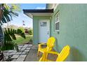 Small front patio with two yellow chairs and a view of the street at 729 N Flamingo Dr, Daytona Beach, FL 32117