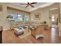 Spacious living room with beige sectional sofa and wood floors at 987 Mori Ct, Port Orange, FL 32127