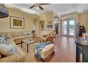 Bright living room featuring a large sectional sofa and hardwood floors at 987 Mori Ct, Port Orange, FL 32127