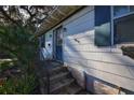 Front entrance with blue door and steps leading up to home at 1116 Magnolia St, New Smyrna Beach, FL 32168