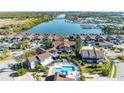 Aerial view of waterfront villas with pool and boat dock, showcasing community's waterfront access and amenities at 113 Lagoon Ct, New Smyrna Beach, FL 32169