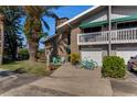 Charming townhome exterior with brick facade, balcony, and vibrant blue bicycles parked in the driveway at 113 Lagoon Ct, New Smyrna Beach, FL 32169