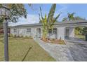 Landscaped walkway leading to a charming home at 1339 N Fowler Dr, Deltona, FL 32725