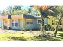 Two-toned home exterior with a unique roofline and lush landscaping at 1506 Palmetto St, New Smyrna Beach, FL 32168