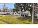 House with a covered porch and large yard, near other homes at 1596 Elizabeth St, New Smyrna Beach, FL 32168