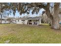 White house with covered porch and a spacious yard at 1596 Elizabeth St, New Smyrna Beach, FL 32168