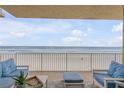 Spacious balcony overlooking the ocean with comfortable seating at 1705 S Atlantic Ave # 302, New Smyrna Beach, FL 32169