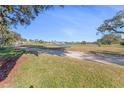 Scenic view of a golf course with homes in the background at 1938 Turnbull Lakes Dr, New Smyrna Beach, FL 32168