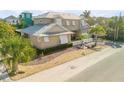 Two-story house with metal roof, landscaping, and a three-car garage at 201 S Cooper St, New Smyrna Beach, FL 32169