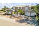 Two-story house with metal roof, white shutters, and a white picket fence at 201 S Cooper St, New Smyrna Beach, FL 32169