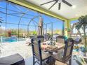 Inviting screened lanai with comfortable seating, a dining area, and a summer kitchen with an outdoor grill at 205 Blue Starfish Pl, Daytona Beach, FL 32124